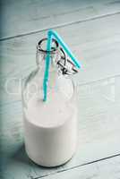 Almand milk in bottle with blue straw