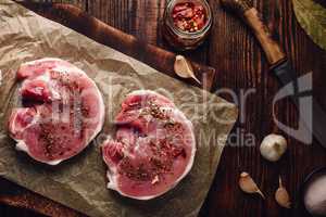 Raw pork loin steaks with different spices