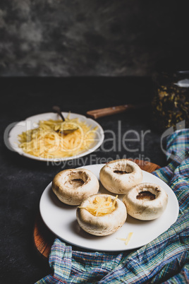 Stuffing mushrooms with grated cheese