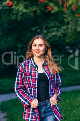 Smiling woman standing in the park