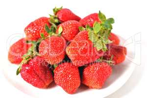 red big strawberries in a white plate on a white background with