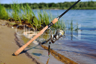 spinning on the bank of the river fishing line silicone bait on