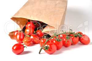 Cherry tomatoes on a branch, paper bag, light background