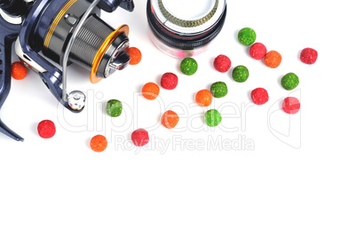 Fishing coil, colored boilies, braided cord, on white background