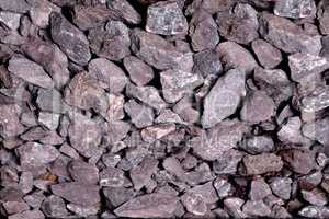 small non-uniform stones burgundy-gray color, background