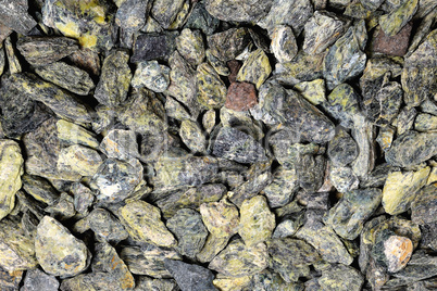small gray-green stones of heterogeneous structure, background
