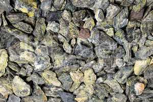 small gray-green stones of heterogeneous structure, background