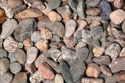 gray rounded stones of heterogeneous structure, background