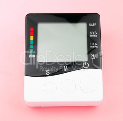 blood pressure monitor on pink background