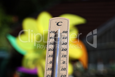 Thermometer shows high temperatures on a hot summer day