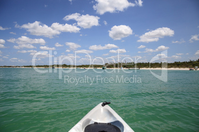 Blue sky over a boat and the beaches of Bonita Springs, Florida