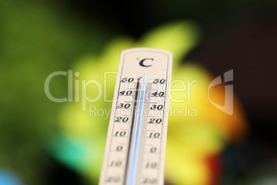 Thermometer shows high temperatures on a hot summer day