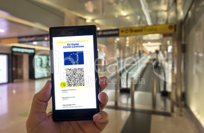 Woman showing on smartphone EU Digital Covid Certificate.