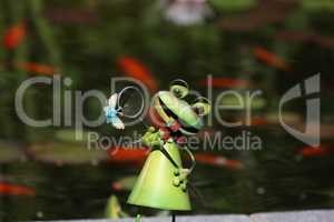 Decorative frog in the garden by the pond