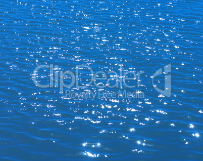 glare on water in city park pond at dry sunny summer day