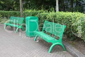 Green metal benches in the park for the recreation of visitors