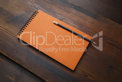 Orange notepad, pencil