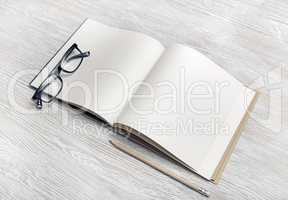 Brochure, pencil, glasses