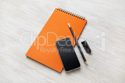 Notepad, smartphone, pencil, eraser