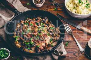 Fried pork neck steak with different mushrooms