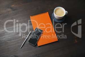 Smartphone, notepad, coffee cup, pen