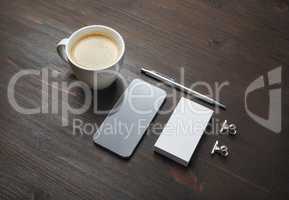 Smartphone, coffee, business card, pen