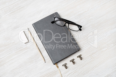 Notebook, glasses, pencil and eraser