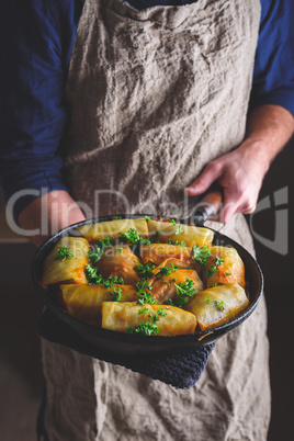 Chef Holding Pan with Cooked Cabbage Rolls