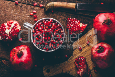 Metal mug full of pomegranate seeds