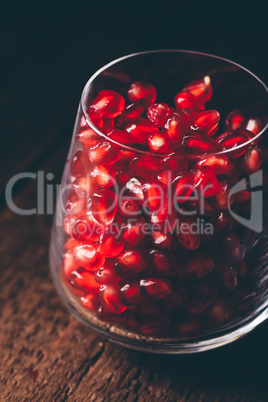 Glass full of red pomegranate seeds