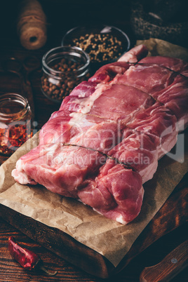Raw pork loin joint on cutting board