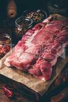 Raw pork loin joint on cutting board