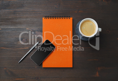 Notebook, smartphone, coffee, pen