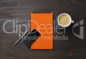 Notebook, smartphone, coffee, pen