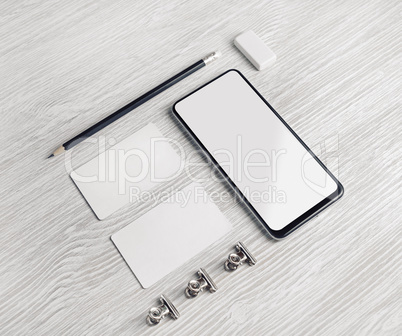 Smartphone, business cards, pencil, eraser