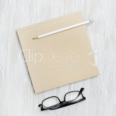 Booklet, glasses, pencil