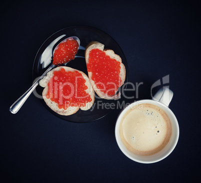 Coffee cup, sandwiches, red caviar