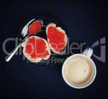 Coffee cup, sandwiches, red caviar