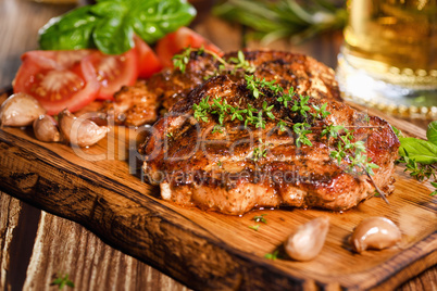 Fried pork steak on a wooden board