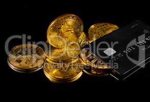 Golden coin with bitcoin logo and credit card . Leader in cryptocurrency BTC and bitcoin rewards card against black surface. Decentralized digital currency. Crypto payment. Electronic money or e-cash