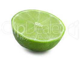 Half of lime isolated on white background. Fresh citrus in the cut. Green fruit full focus.