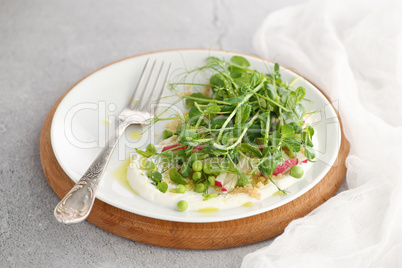 vegan healthy salad made of microgreen sprouts peas