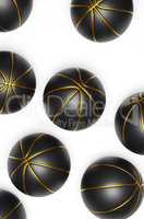 Many black basketballs with gold on a bright background
