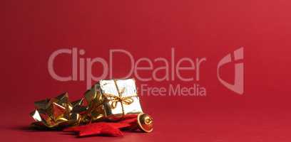 Christmas decoration in gold on a red paper background with spac
