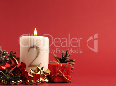 White candle with the number two burns, Advent background White candle with the number two burns, Advent background