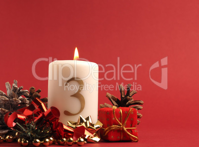 White candle with the number three burns, Advent background