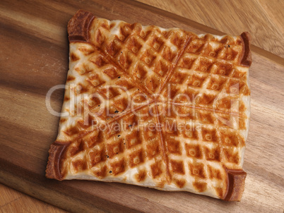 Waffle from puff pastry on a wooden board