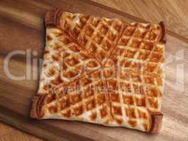 Waffle from puff pastry on a wooden board