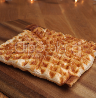 Waffle from puff pastry on a wooden board