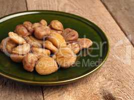 Organic chestnuts on a rustic green plate